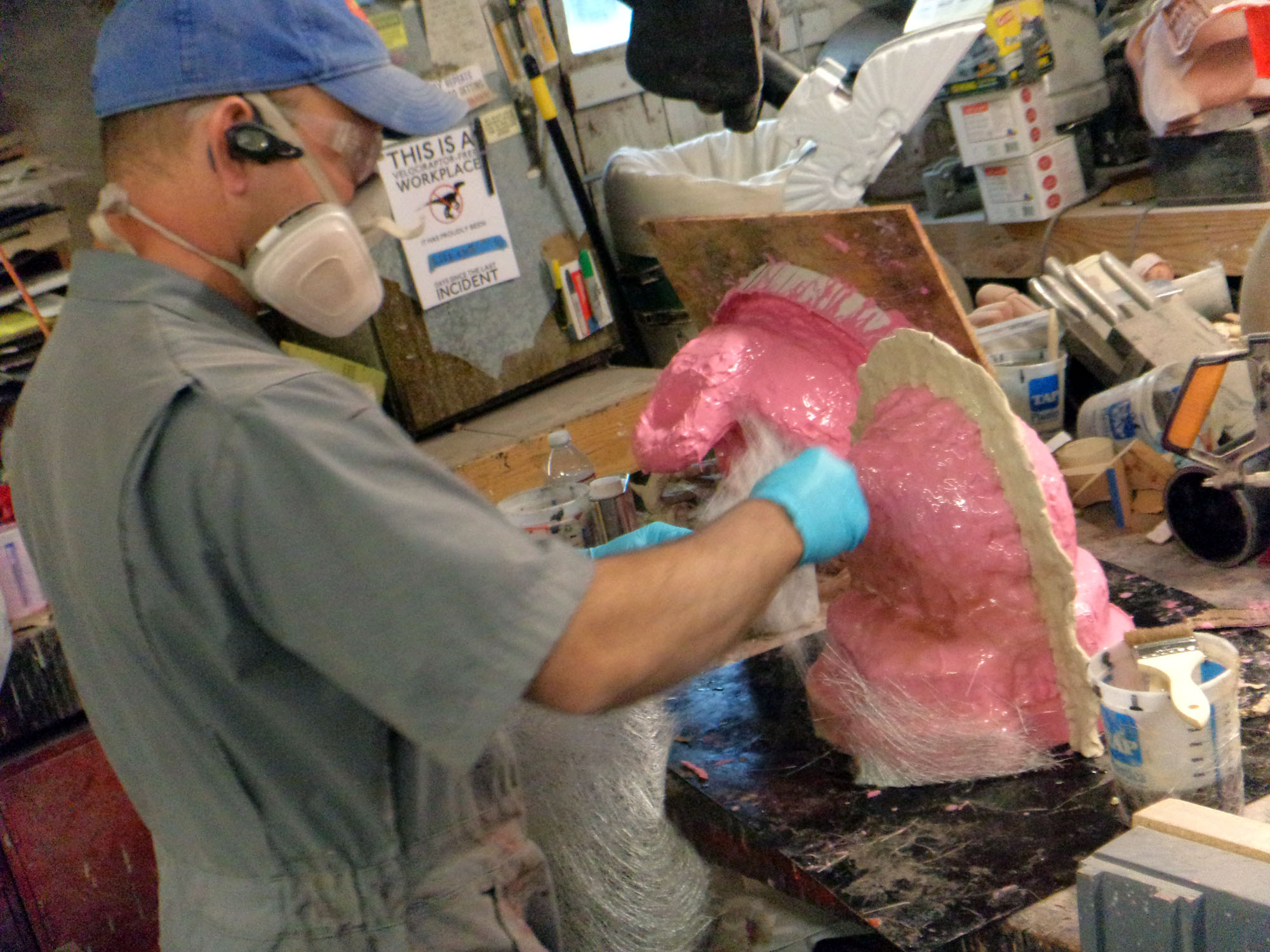 Laying up fiberglass mothermold.